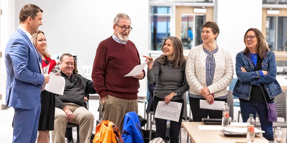 City councilors Nathan Fennessy (left), Amanda Grady Sexton, Mayor Byron Champlin, Stacey Brown, Judith Kurtz, and Jennifer Kretovic (all standing) are part of the green group in exercise in personality types at the council orientation at the Concord Community Center on Wednesday night, January 3, 2024.