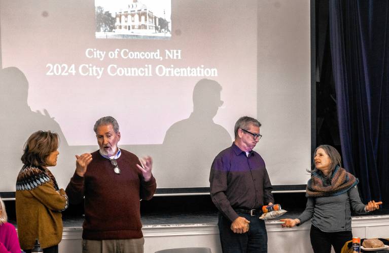 City councilor Karen McNamara (left) talks with Mayor Byron Champlin as councilors Fred Keach and Stacey Brown talk at the council orientation at the Community Center on Wednesday night, January 3, 2024.