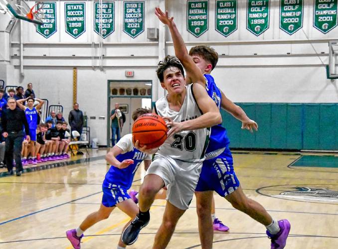 Pembroke’s Joe Fitzgerald drives past a Pelham defender towards the basket on Friday at Pembroke Academy. Fitzgerald scored a game-high 23 points to lead the Spartans over the Pythons, 55-54, in a rematch of last season’s Division II championship game.
