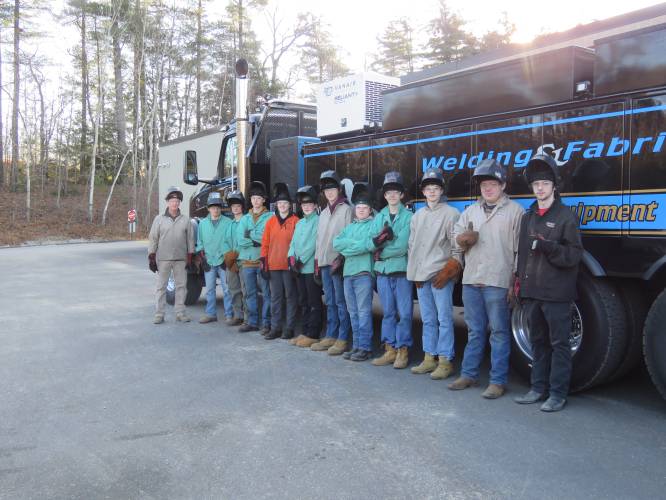 (From left) JSRHS Tech Ed Teacher Joab Owen with his Intro to Welding class stand by an MDS Welding truck. 