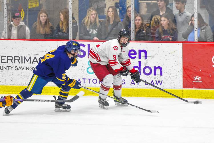 Concord sophomore Carter Doherty looks to make a pass as Bow defenseman Massimo Palelli closes in on him during Wednesday night’s 2-1 victory for the Tide.