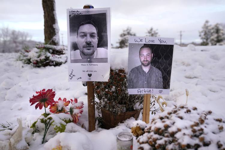 FILE - Pictures of two of the victims of the October 2023 mass shooting by Army reservist Robert Card are seen at a makeshift memorial in Lewiston, Maine, Dec. 5, 2023. Despite the warning by Card's friend and fellow Army reservist Sean Hodgson, which came alongside a series of other glaring red flags, Army officials discounted the warnings and ultimately did not stop Card from committing Maine's deadliest mass shooting when he killed multiple people in Lewiston. (AP Photo/Robert...
