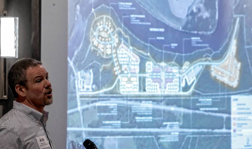 Kevin Lacasse, CEO of New England Family Housing, shows the proposal plans for the Monitor Way project at the Greater Concord Chamber of Commerce luncheon on Thursday.