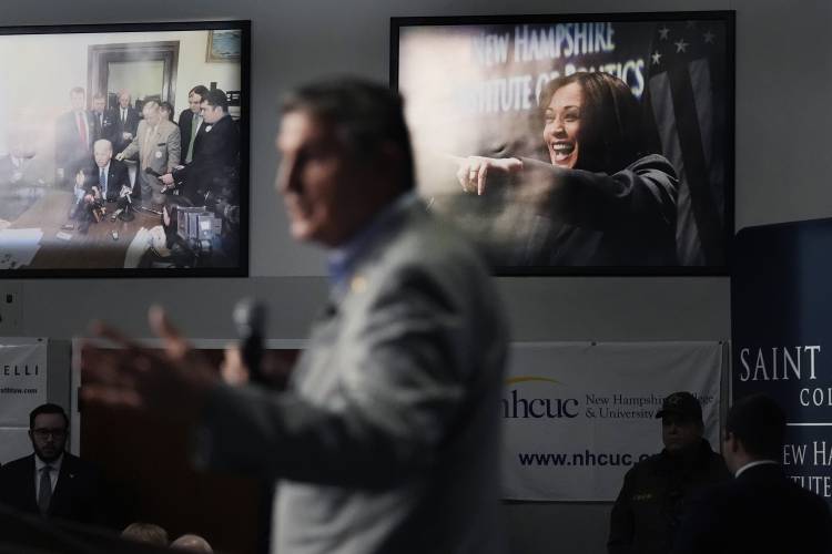 Sen. Joe Manchin, D-W.Va., speaks during the 'Politics and Eggs' event, as part of his national listening tour, Friday, Jan. 12, 2024, in Manchester, N.H. Sen. Manchin announced last November that he would not seek reelection in 2024 and has teased a potential third-party run for the presidency. At rear are photographs of President Biden, rear left, and Vice President Harris, rear right. (AP Photo/Charles Krupa)