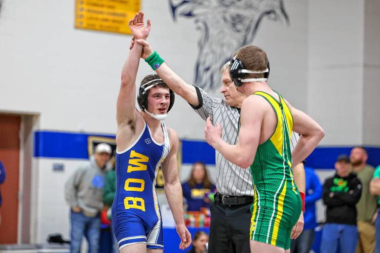 The referee raises Bow wrestler Jared Dolder’s hand after Dolder defeated Bishop Guertin’s Jack Fostter in double overtime in a match at 150 pounds at Bow’s quad meet on Saturday. Dolder went 3-0 as the Falcons defeated Manchester Central, 69-12, Manchester Memorial, 45-12, and Bishop Guertin, 43-32.