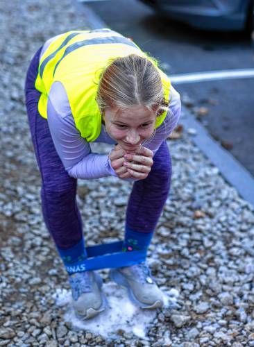 Concord Nordic skier Phoebe Dater-Roberts balances on a small mound of snow as she warms up during practice.