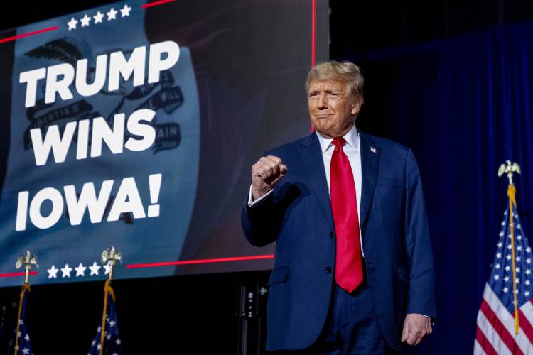 Republican presidential candidate former President Donald Trump takes the stage at a caucus night party in Des Moines, Iowa, Monday, Jan. 15, 2024. (AP Photo/Andrew Harnik)
