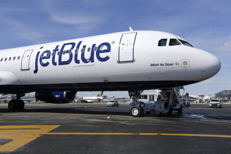 FILE - A JetBlue airplane is shown at John F. Kennedy International Airport in New York, March 16, 2017. A federal judge is siding with the Biden administration and blocking JetBlue Airways from buying Spirit Airlines, saying the 3.8 billion deal would reduce competition. The Justice Department sued to block the merger, saying it would drive up fares by eliminating Spirit, the nation’s biggest low-cost airline. (AP Photo/Seth Wenig, File)