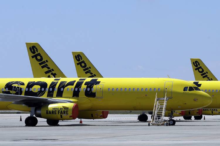 FLE - A line of Spirit Airlines jets sit on the tarmac at the Orlando International Airport on May 20, 2020, in Orlando, Fla. A federal judge is siding with the Biden administration and blocking JetBlue Airways from buying Spirit Airlines, saying the 3.8 billion deal would reduce competition. The Justice Department sued to block the merger, saying it would drive up fares by eliminating Spirit, the nation’s biggest low-cost airline. (AP Photo/Chris O'Meara, File)