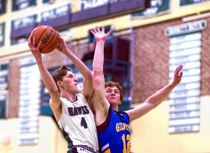 Hopkinton forward Kristof Cauley gets fouled by Gilford forward Cooper Perkins as he goes up for a shot during the first half on Wednesday.