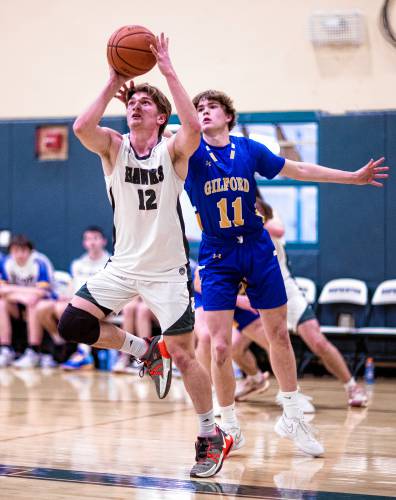 Hopkinton guard Colby Boissy goes up for a shot against Gilford forward Ben Normand during the first half on Wednesday, January 17, 2024.
