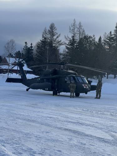 NH Army National Guard members attempt a helicopter extraction.