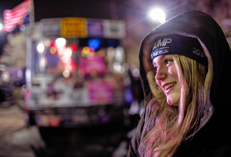 Kate Benner of Andover waits in line outside the Courtyard by Marriot in Concord to get in to see former President Donald Trump on Friday night, January 19, 2024.