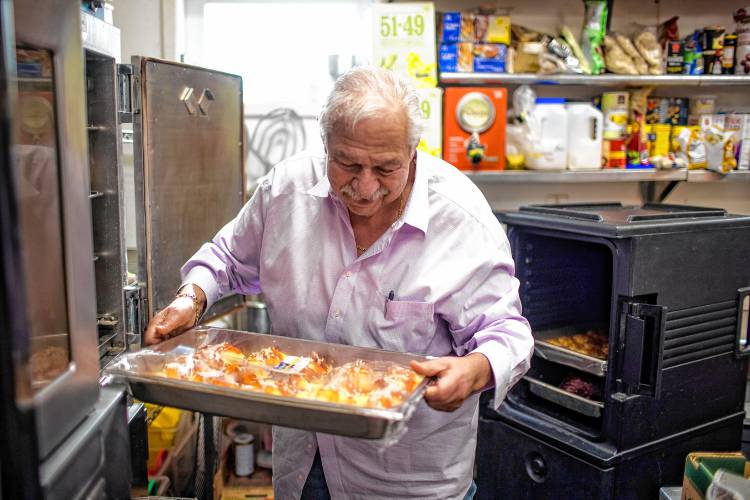 Alan Andrian takes out manicotti that goes out to the Hospice House to feed not only patients but their familites and staff at the Alanâs of Boscawen kitchen on Friday, January 19, 2024.