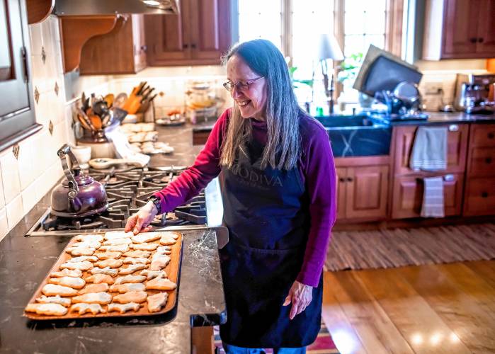 Janet DeVito of Hopkinton gets ready to put on the frosting on her election cookies on Monday, January 22, 2024.