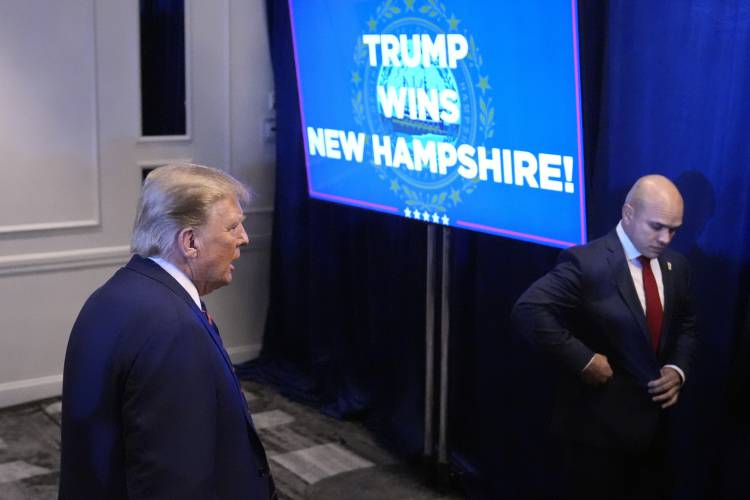 Republican presidential candidate former President Donald Trump walks backstage after speaking at a primary election night party in Nashua, N.H., Tuesday, Jan. 23, 2024. At left is valet Walt Nauta. (AP Photo/Matt Rourke)