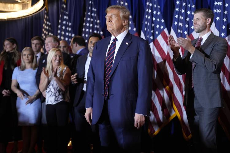 Republican presidential candidate former President Donald Trump arrives to speak at a primary election night party in Nashua, N.H., Tuesday, Jan. 23, 2024. At right is Eric Trump. (AP Photo/Matt Rourke)
