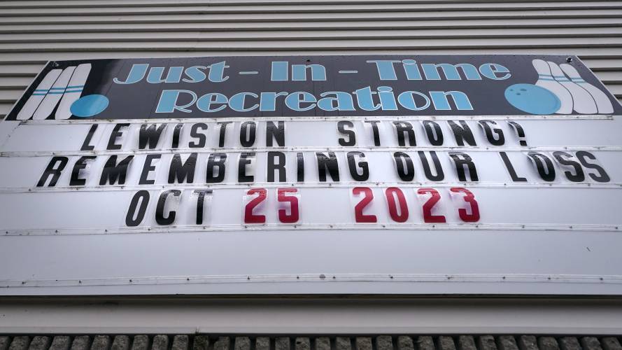 A sign stating “Lewiston Strong!” is displayed outside the Just-In-Time bowling alley, one of the sites of the shootings.