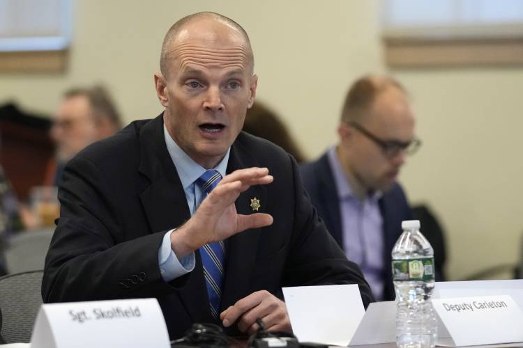 Deputy Chad Carleton responds to questioning, Thursday, Jan. 25, 2024, in Augusta, Maine, during a hearing of the independent commission investigating the law enforcement response to the mass shooting in Lewiston, Maine. Carleton is one of the individual officers who handed early complaints about shooter Robert Card.(AP Photo/Robert F. Bukaty)
