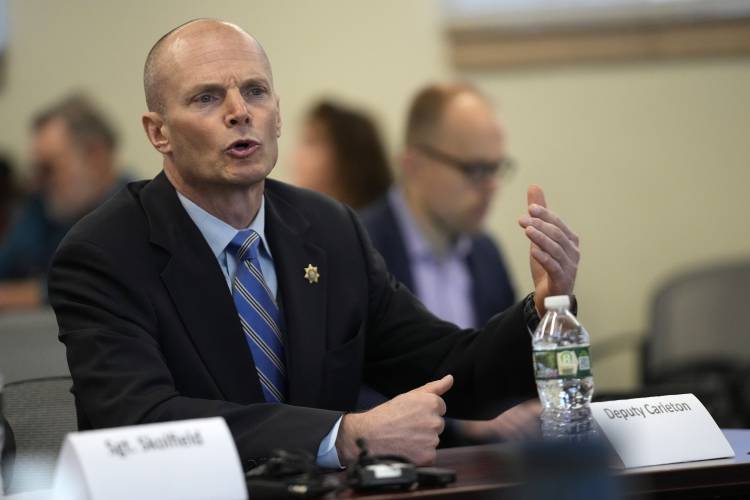 Deputy Chad Carleton responds to questioning, Thursday, Jan. 25, 2024, in Augusta, Maine, during a hearing of the independent commission investigating the law enforcement response to the mass shooting in Lewiston, Maine. Carleton is one of the individual officers who handed early complaints about shooter Robert Card.(AP Photo/Robert F. Bukaty)