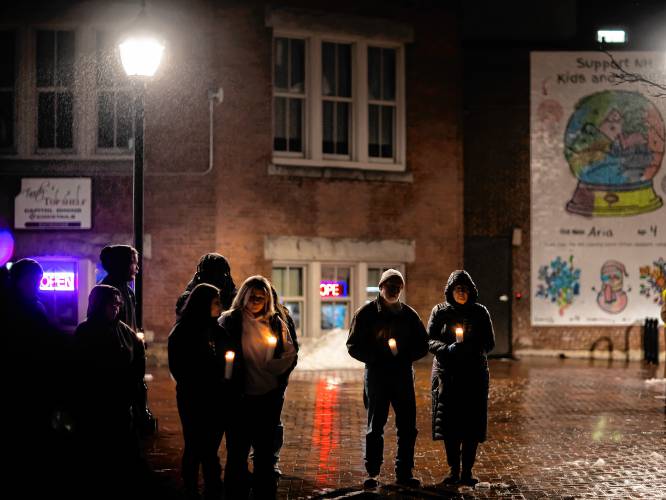 Attendees hold candles during the vigil for Zackary Sullivan at Eagle Square on Friday night.