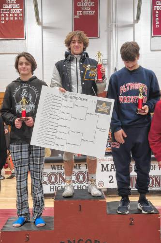 Bow’s Adler Moura (center) stands at the top of the podium with his trophy after winning the 113-pound title at the Capital City Classic at Concord High School on Saturday.