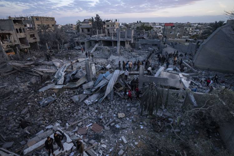 Palestinians look at a mosque destroyed in an Israeli strike in Rafah, Gaza Strip, Wednesday, Jan. 24.