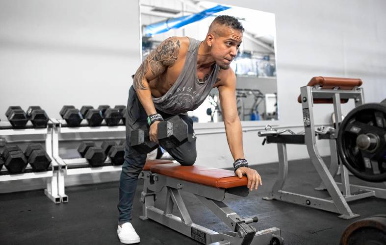 Mark Vincent gets in a workout before going to work at the front desk of Capital City Sports and Fitness on Friday.