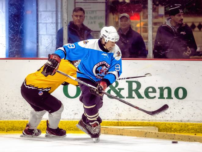 Jim Heath of the Concord Budmen battles along the boards during a game on Friday, March 17, 2023. The Budmen lost their first match.