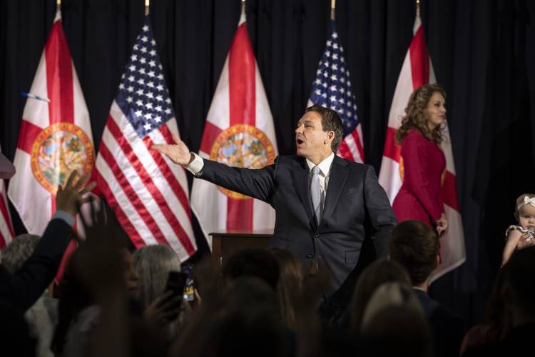 TAMPA, FL - MAY 17: Florida Gov. Ron DeSantis throws pens into the crowd after signing a series of education bills at Cambridge Christian school in Tampa, Fla. on Wednesday, May 17, 2023. (Photo by Thomas Simonetti for The Washington Post)