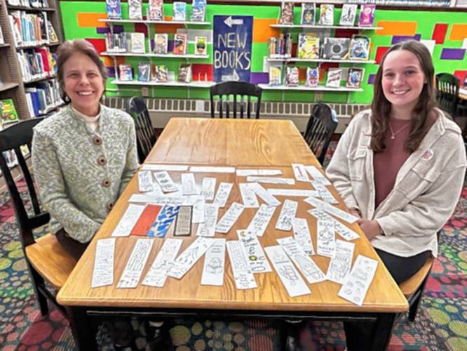 Tucker Free Library Children’s Librarian Erin Lognan with JSRHS Senior Ava Martin with the bookmarks from Ava’s National Honor Society Project for the library.