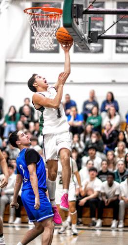 Pembroke guard Evan Berkeley scores at the rim during the second half against Manchester West on Tuesday night, January 30, 2024.