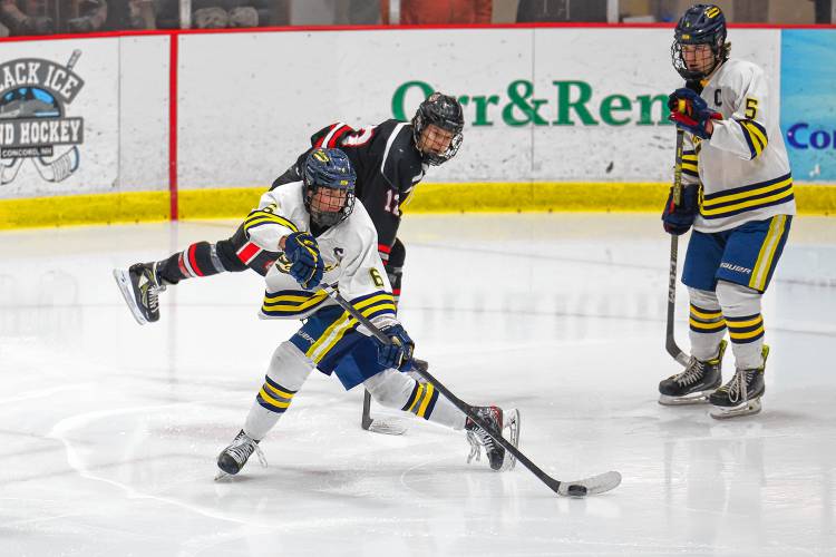 Bow senior Billy Smethurst passes the puck during Wednesday’s 5-1 loss to Bedford.