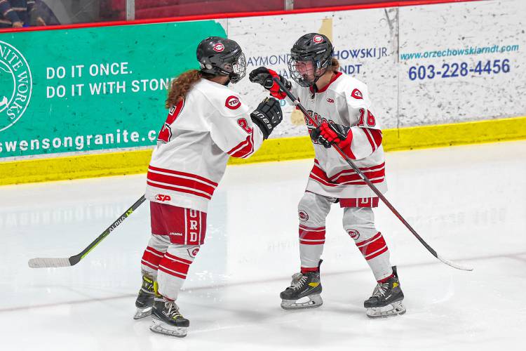 Gracen Arndt (right) celebrates with Evianna Raimo after one of Raimo’s two goals scored in Concord’s 4-3 win over Kingswood-Prospect Mountain on Wednesday.