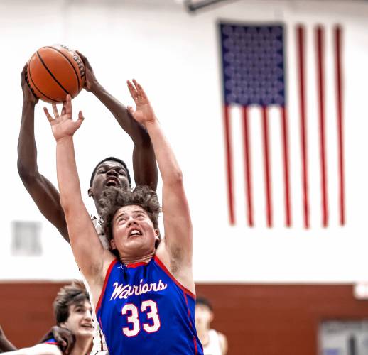 Concord forward Alain Twite outrebounds Winnacunnet forward Edgar Hansen (33) during the second half on Friday night.