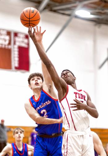 Concord forward Alain Twite drives to the hoop as Winnacunnet guard Timothy Kollmorgen tries to defend him during the first quarter on Friday night.
