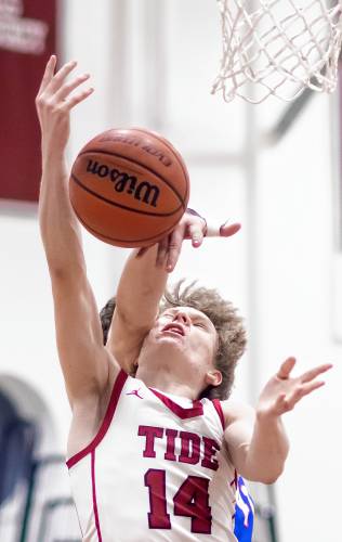 Concord guard Chase Lawler gets fouled from behind as he drives to the basket during the first half against Winnacunnet on Friday night.