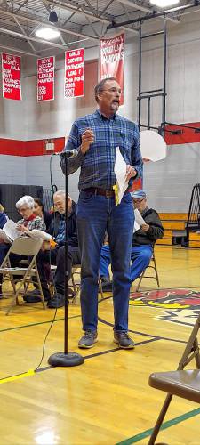 Mike Keeler addresses fellow residents  at the Epsom deliberative session on Saturday morning about a petitioned warrant article to restrict gun dealers from residential areas of town.