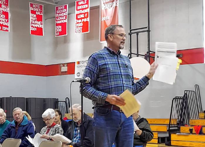 Mike Keeler addresses fellow residents at the Epsom deliberative session on Saturday morning about a petitioned warrant article to restrict gun dealers from residential areas of town.