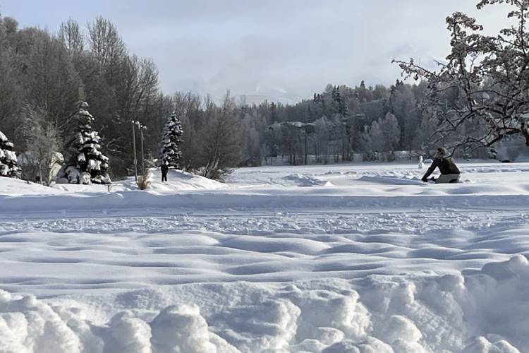 A man rides a fat tire bike on a plowed sidewalk through Westchester Lagoon in Anchorage, Alaska, Thursday, Feb. 1, 2024. Much of Alaska has plunged into a deep freeze, with temperatures well below zero and Anchorage seeing some of its coldest temperatures in years. (AP Photo/Mark Thiessen)