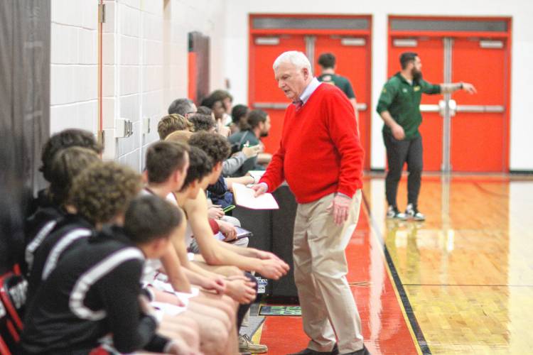 Dave Smith talks to some of his Coe-Brown basketball players during a game against Bishop Brady High School last January.