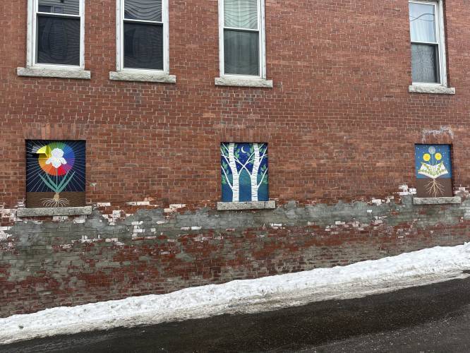 Murals deemed objectionable by some residents hang on the side of building in Littleton, N.H., on Jan 23, 2024. Littleton town manager Jim Gleason, whose late son was gay, resigned effective Friday, Feb. 2, 2024, to take a stand against the anti-LGBTQ sentiments being expressed by some people in Littleton. The quaint town of Littleton is seeing more tourists, drawn to a main street of shops and restaurants where rainbow colors and gay pride symbols can be seen alongside American...
