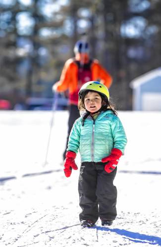 Mai Evans, 3, after she finished her cross country lesson on the trails at Beaver Meadow Golf Course on Sunday.