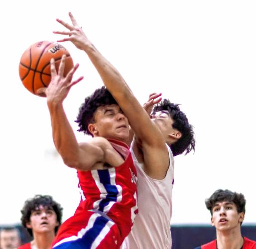 John Stark forward Donnie White gets fouled by Coe-Brown guard Matthew Flanagan as he drives to the basket during the first half on Tuesday night, February 6, 2024.