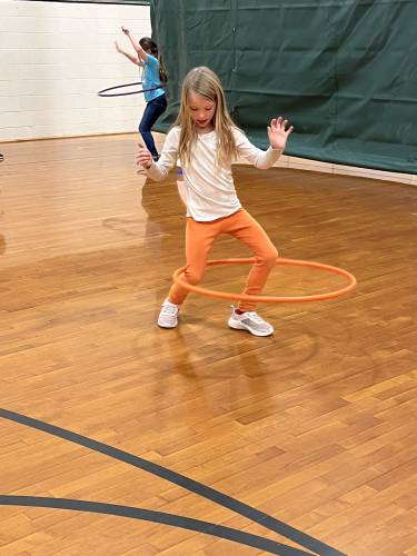 Ruby Hattan hula hooping during gym class in Henniker.