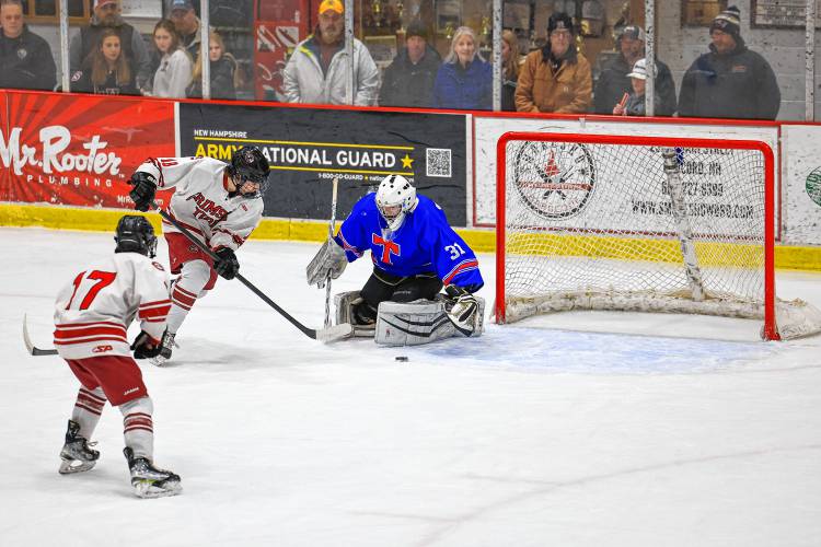 Concord junior Rowan Arndt tries to work the puck around Trinity goalie Brendan Heppler during Wednesday's matchup. Arndt scored twice in the Tide's 4-2 win.