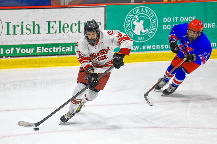 Concord senior defenseman Jordan Dustin brings the puck up the ice for the Tide during its 4-2 victory over Trinity on Wednesday, Feb. 7, 2024.