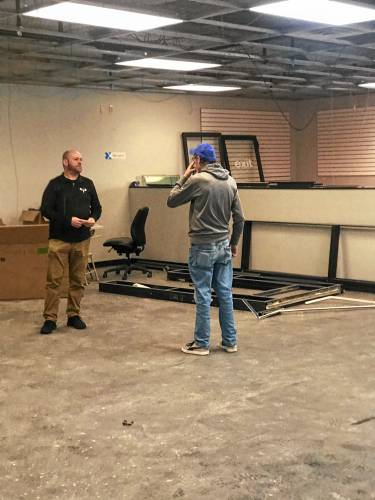 Co-owner Jeff Burnham  speaks to a sales rep at Capital City Billiards.