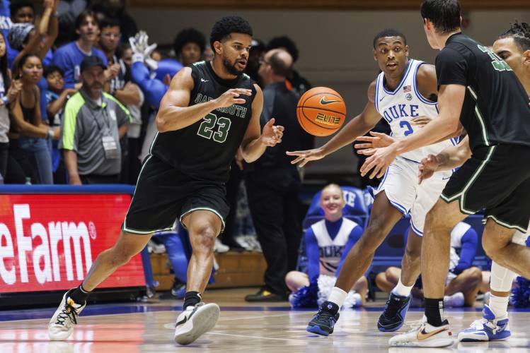 Dartmouth’s Robert McRae III (23) takes a pass from Jackson Munro (33) as Duke’s Jaylen Blakes (2) defends during a Nov. 6 game in Durham, N.C. A National Labor Relations Board regional official has decided that Dartmouth basketball players are employees of the school, clearing the way for an election that would create the first labor union for NCAA athletes.