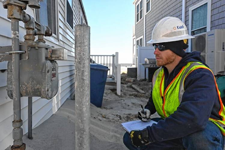 Unitil gas technician Scott Murray checks gas service meters at Hampton Beach after historic high-tide flooding on Jan. 13. (Courtesy of Unitil)